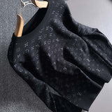Close-up detail shot of Louis Vuitton luxury clothing with logo-detail design