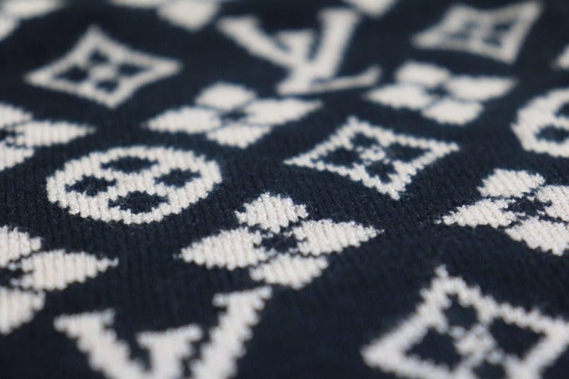 Flat lay presentation of Louis Vuitton luxury clothing with logo-detail design