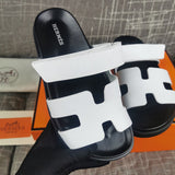 Hermès Black Slide Sandals - Angled View
