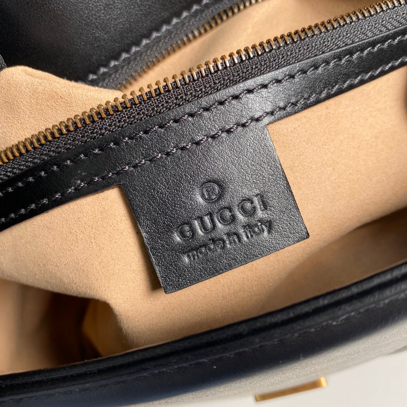 Side profile of refined polished women's handbag – women's luxury accessory