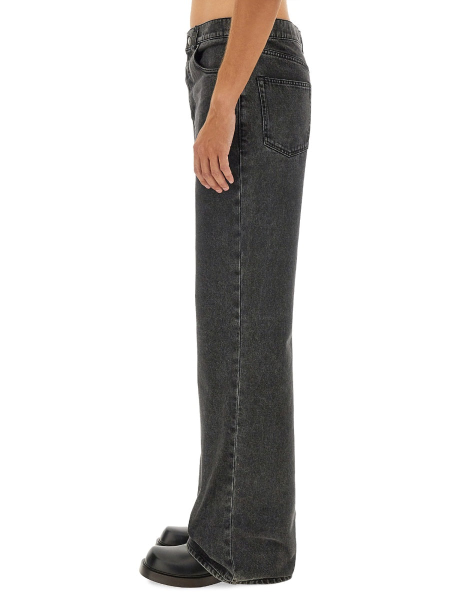 Close-up of Alexander McQueen pants hardware and fine stitching