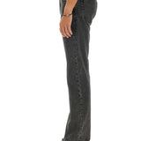 Close-up of Alexander McQueen pants hardware and fine stitching