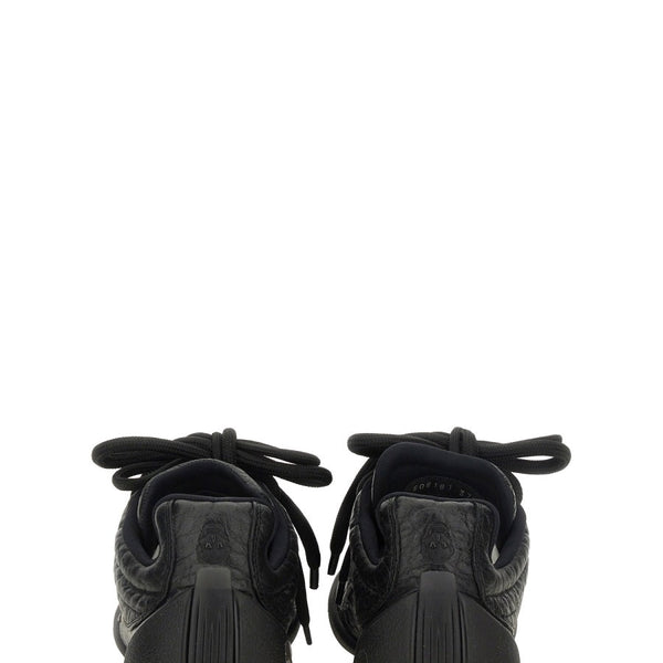 Close-up of Alexander McQueen athletic hardware and fine stitching