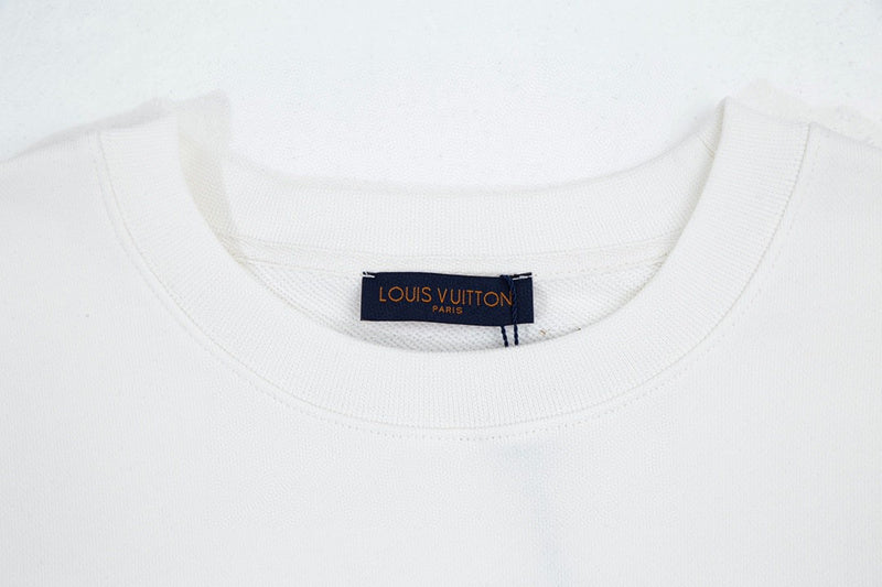 Flat lay presentation of Louis Vuitton luxury clothing with signature branding