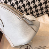Side view of clean-lined structured handbag