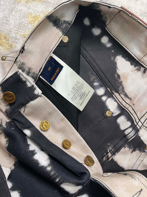 Flat lay presentation of Louis Vuitton luxury clothing with label-forward styling