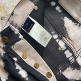 Flat lay presentation of Louis Vuitton luxury clothing with label-forward styling