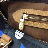 Side profile of signature polished women's handbag – women's luxury accessory