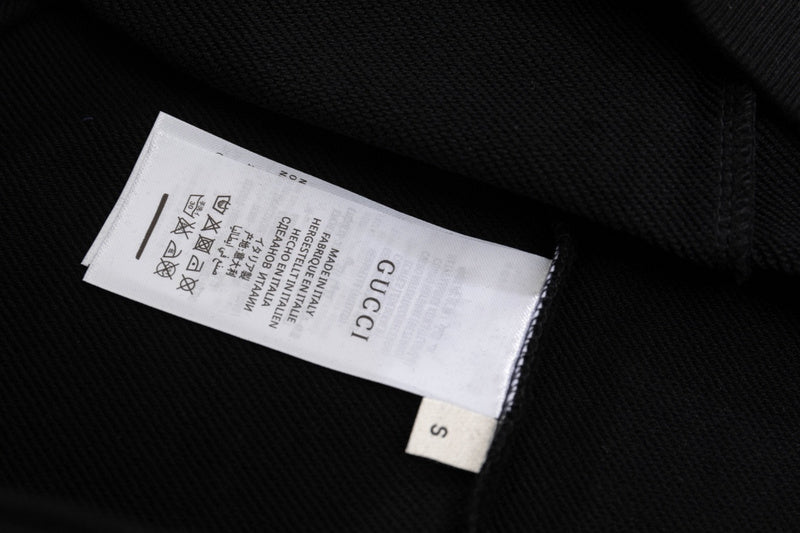 Close-up detail shot of Gucci luxury clothing with relaxed-fit cut