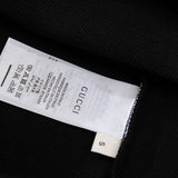Close-up detail shot of Gucci luxury clothing with relaxed-fit cut