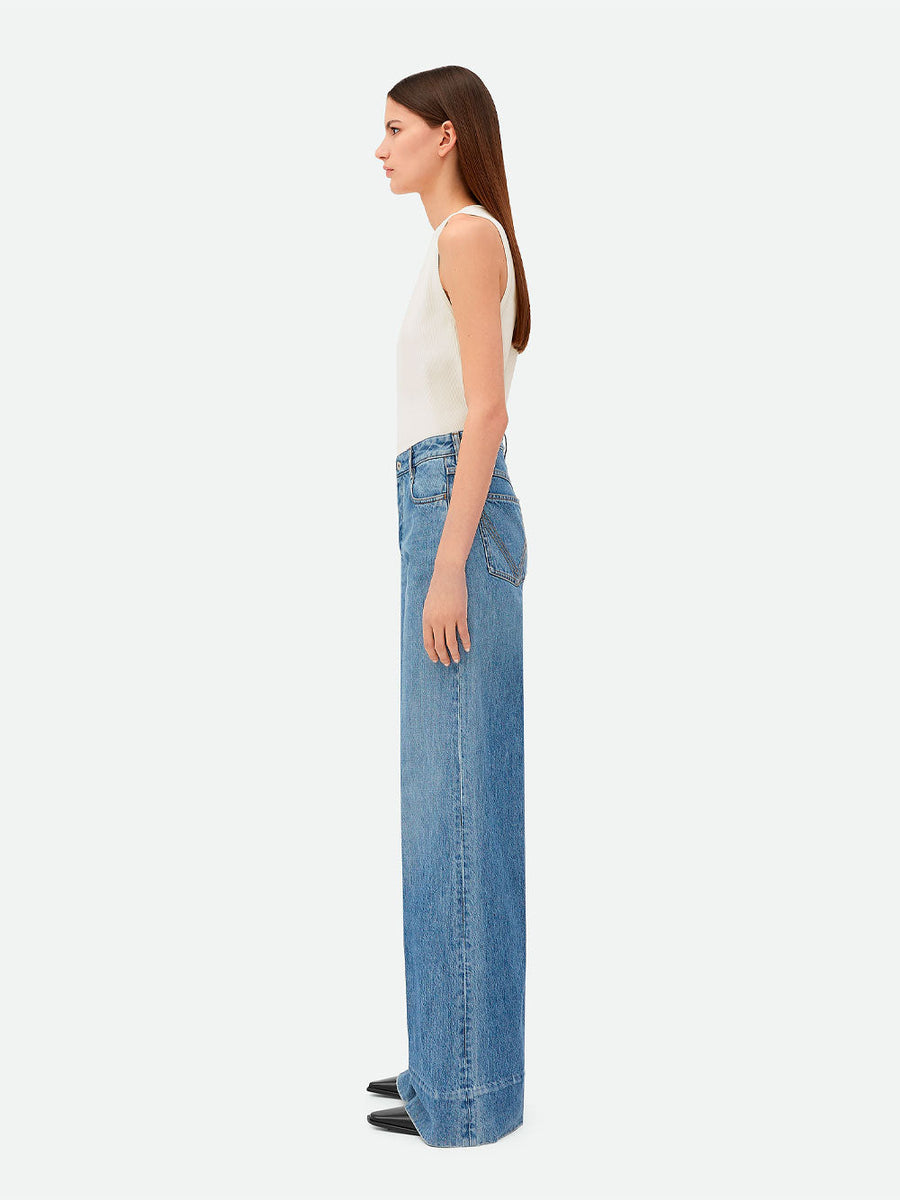 Close-up of Bottega Veneta pants hardware and fine stitching