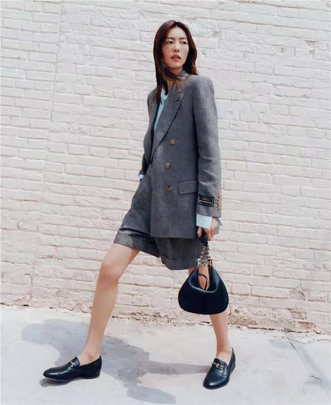Side profile of elevated signature women's handbag – women's designer-style accessory