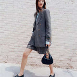 Side profile of elevated signature women's handbag – women's designer-style accessory