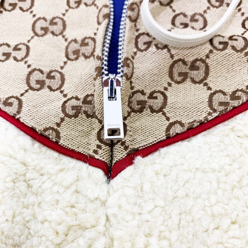 Flat lay presentation of Gucci luxury clothing with label-forward styling