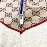Flat lay presentation of Gucci luxury clothing with label-forward styling