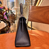 Side view of sleek structured handbag