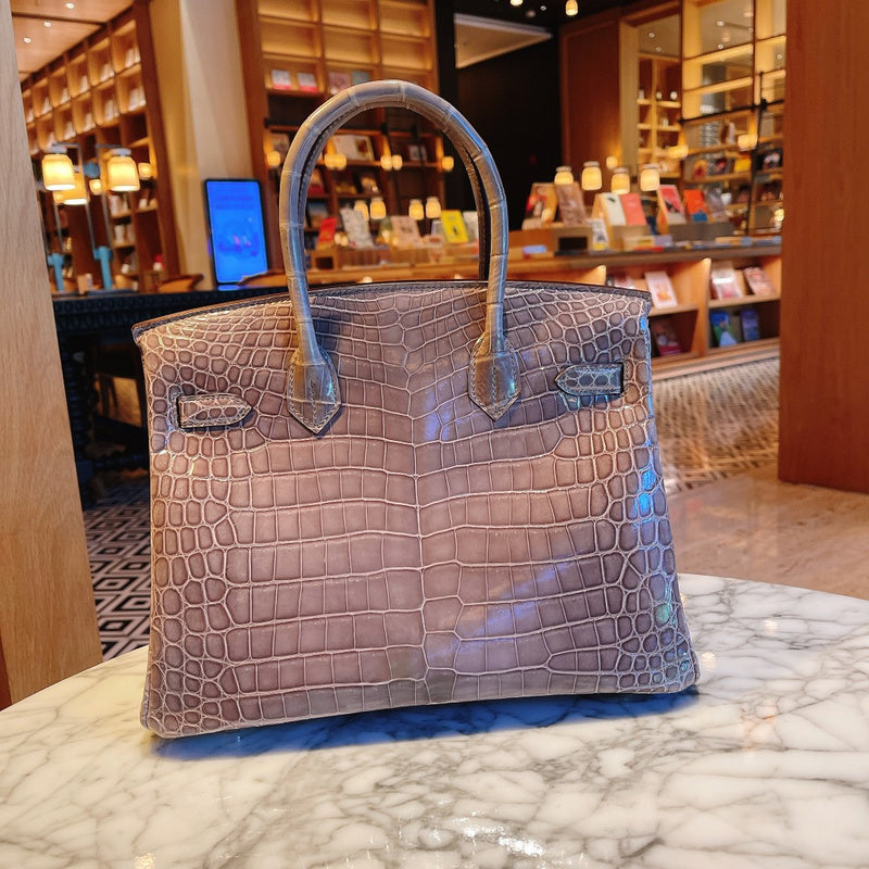 Side view of streamlined structured handbag