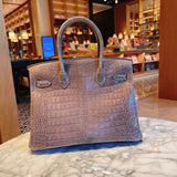 Side view of streamlined structured handbag