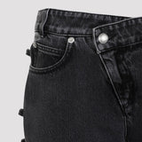 Close-up of Alexander McQueen pants hardware and fine stitching