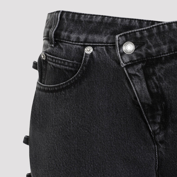 Close-up of Alexander McQueen pants hardware and fine stitching
