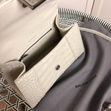 Front view of modern polished women's handbag – women's designer-style accessory
