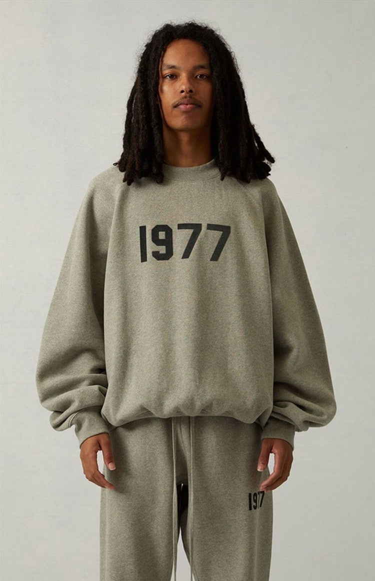 Fear of God Essentials Sweatshirt flat lay on neutral background