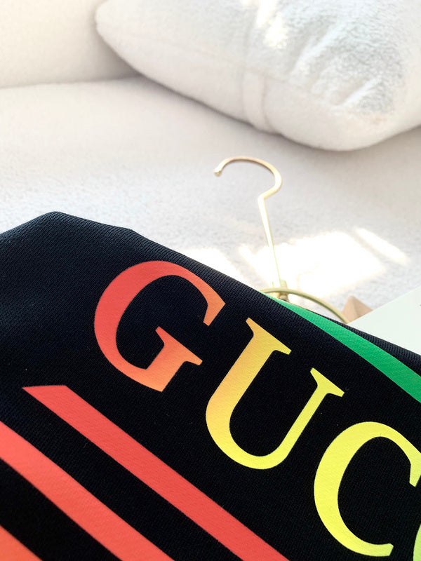 Close-up detail shot of Gucci luxury clothing with logo-detail design