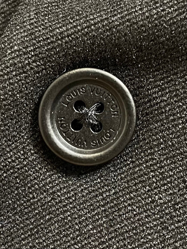 Flat lay presentation of Louis Vuitton luxury clothing with signature branding
