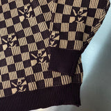 Close-up detail shot of Louis Vuitton luxury clothing with monogram-inspired silhouette