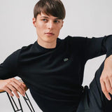 Side profile of Lacoste luxury clothing with monogram-inspired silhouette