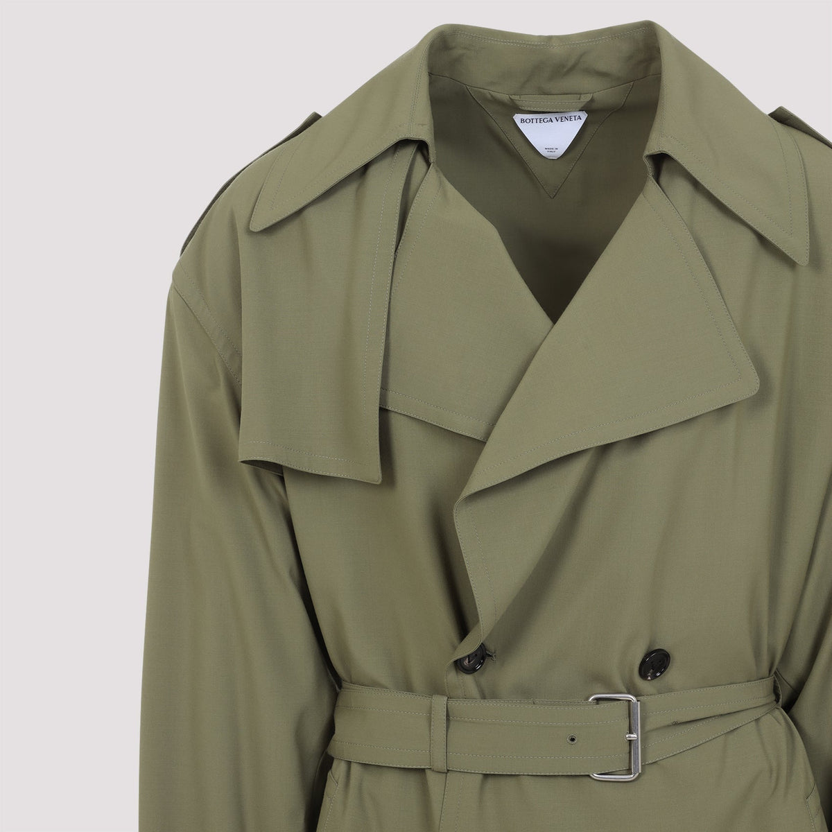 Close-up of Bottega Veneta coats hardware and fine stitching