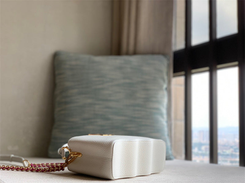  polished top-handle bag styled with outfit