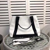 Handle and strap detail of modern statement women's handbag – women's luxury handbag