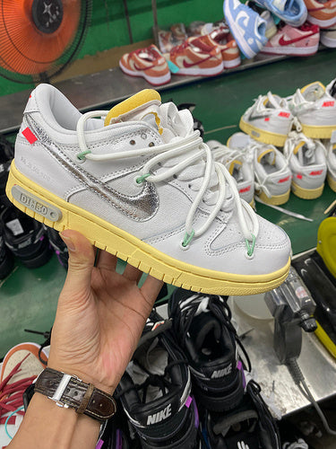 Side profile of Nike two-tone sneakers streetwear statement look