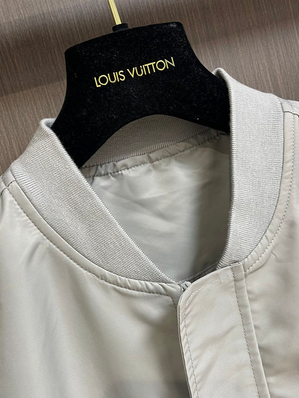 Close-up detail shot of Louis Vuitton luxury clothing with label-forward styling