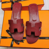 Hermès Chocolate Brown Slide Sandals - Angled View