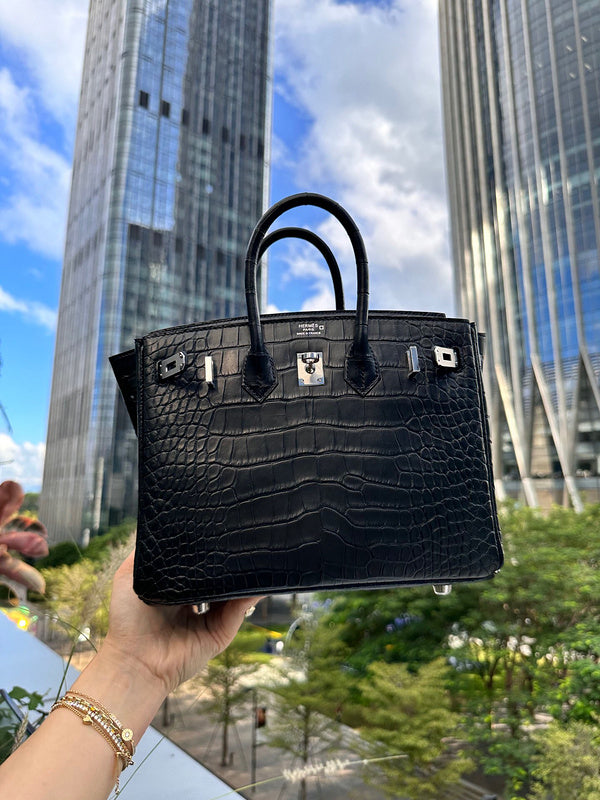 Side view of sculpted structured handbag
