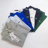Flat lay presentation of Lacoste luxury clothing with signature branding