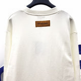 Back view of Louis Vuitton luxury clothing with label-forward styling
