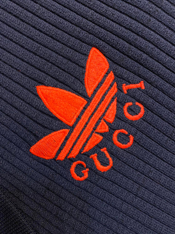 Flat lay presentation of Gucci luxury clothing with label-forward styling
