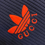 Flat lay presentation of Gucci luxury clothing with label-forward styling
