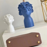 Styled lifestyle shot of structured statement women's handbag – women's everyday handbag