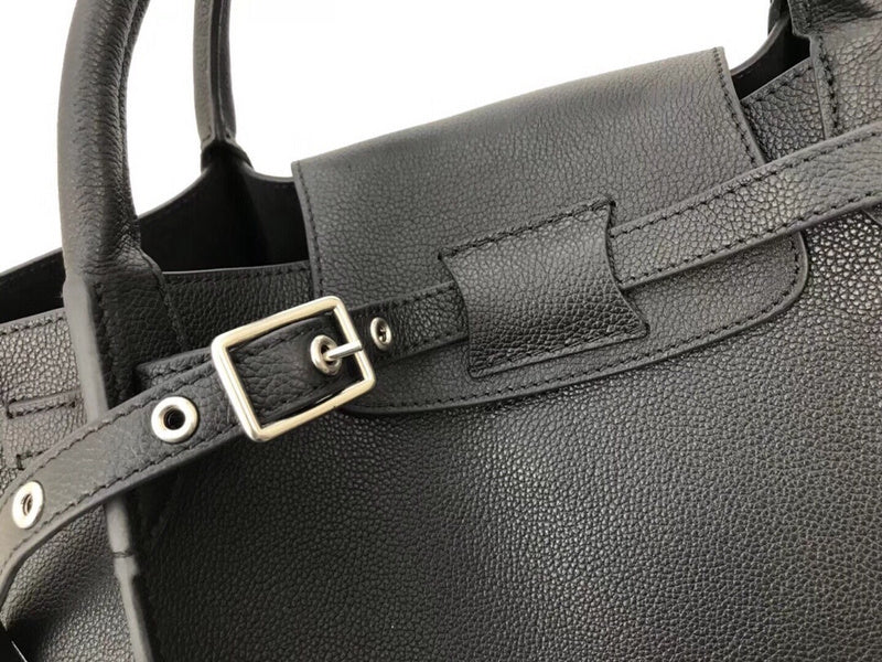 Handle and strap detail of modern statement women's handbag – women's designer-style accessory