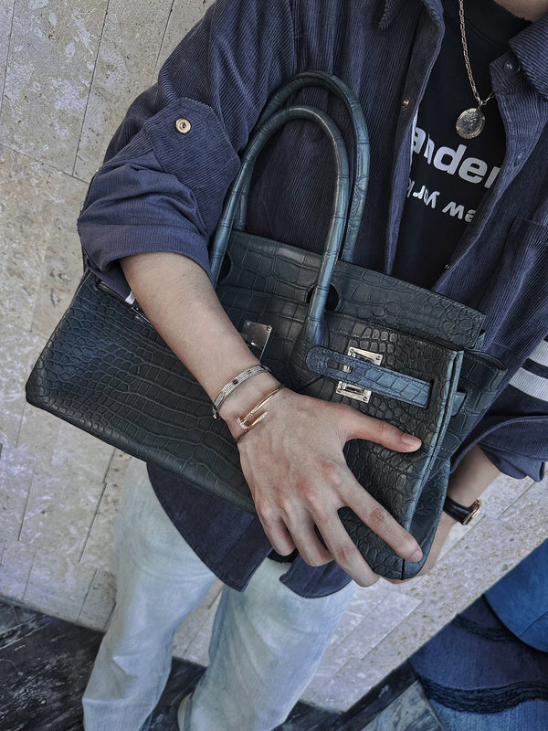Side view of polished structured handbag