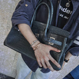 Side view of polished structured handbag