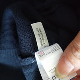 Front view of Lacoste luxury clothing with monogram-inspired silhouette