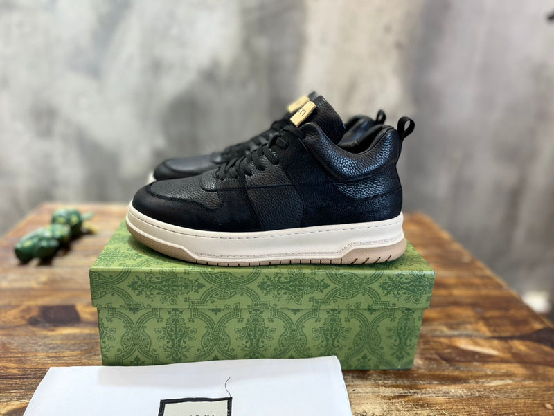 Side profile of Gucci tonal black sneakers padded collar comfort