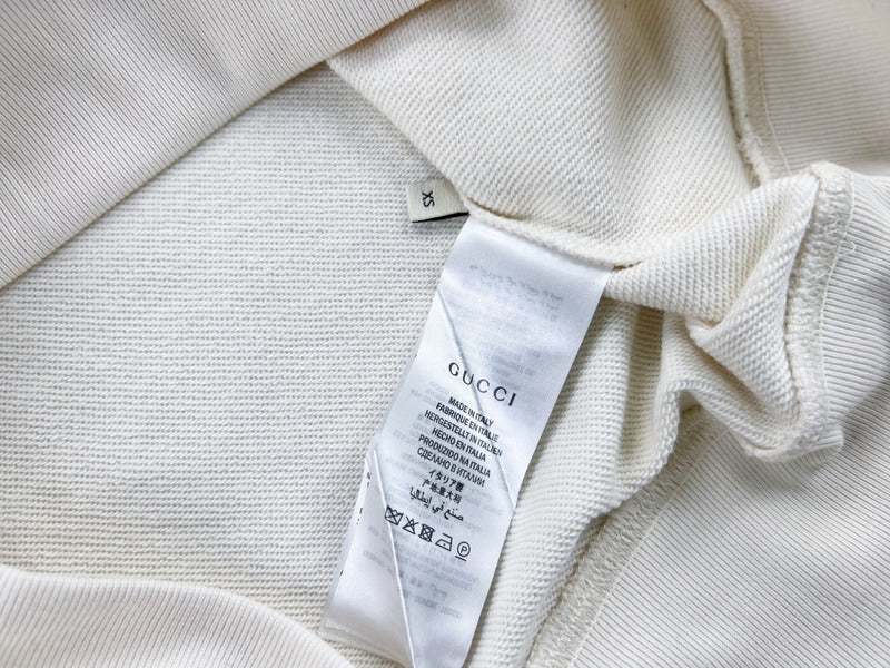 Close-up detail shot of Gucci luxury clothing with signature branding