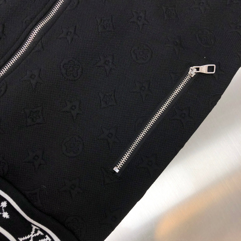 Flat lay presentation of Louis Vuitton luxury clothing with signature branding