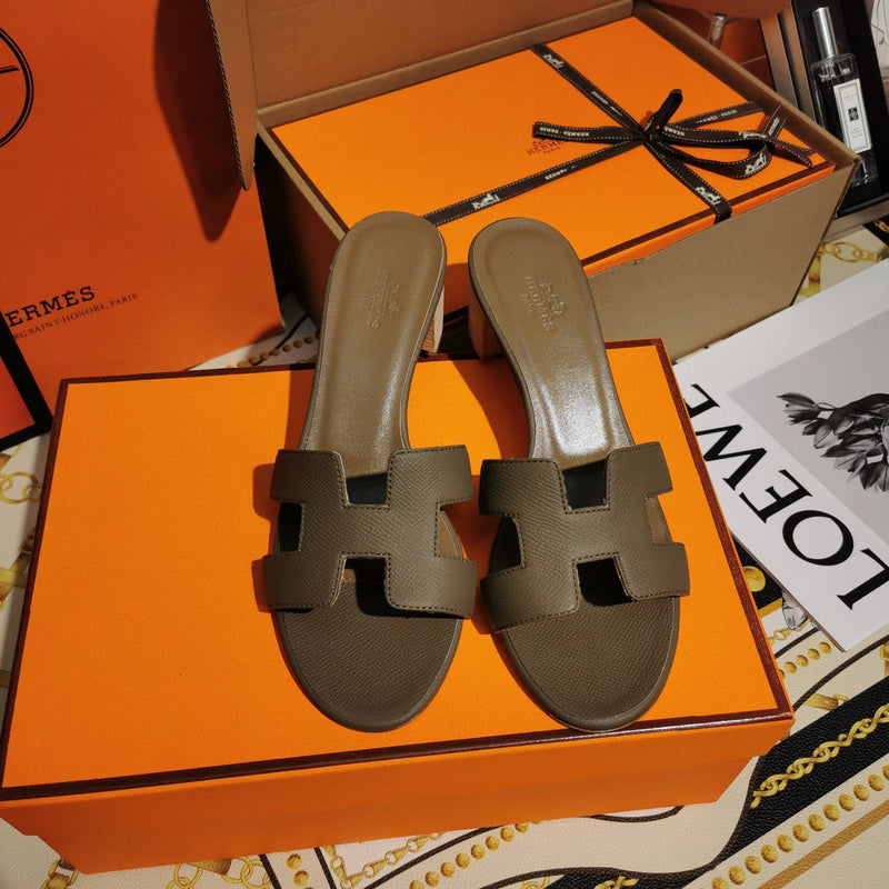 Hermès Tan Flat Thong Sandals - Angled View